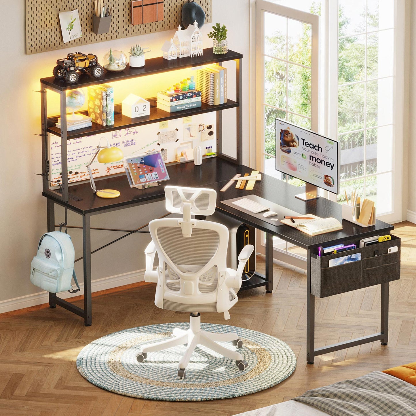 Black 135cm x 100cm L-shaped desk with upper storage hutch, LED lighting, and side hanging fabric drawer organizer, used as a student study and computer desk.