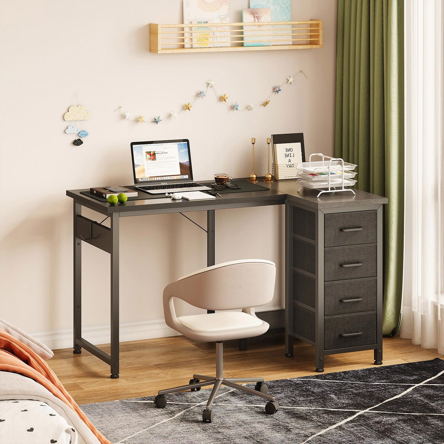 Black 100cm x 70cm L-shaped desk with 4 fabric drawers in a bedroom home office scene, with right-side fabric drawer storage, side hanging pocket, and space-saving corner layout.