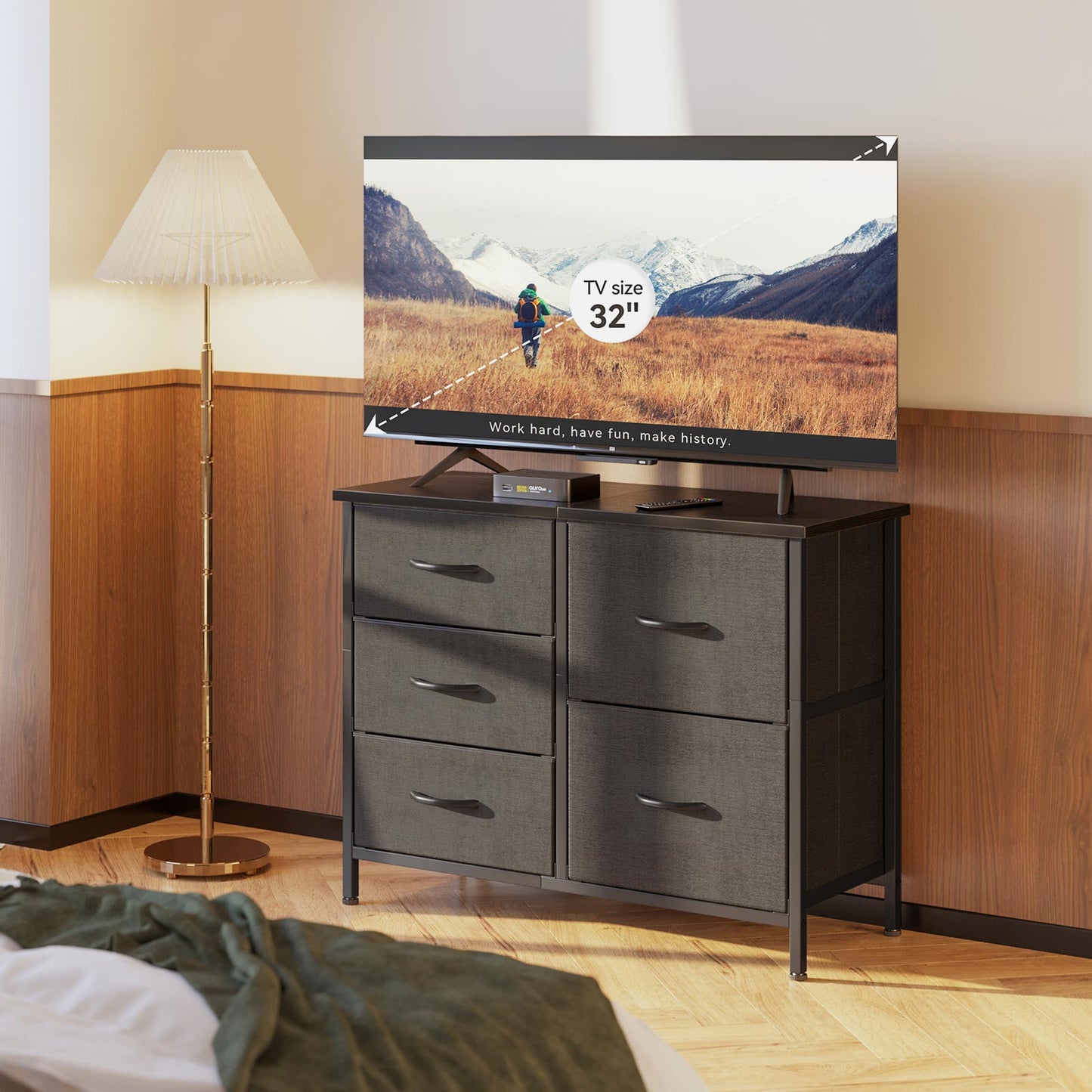 Black double-wide 3-tier 5-drawer fabric storage dresser used as a bedroom TV stand, with a wood top supporting up to a 32-inch TV and extra drawer storage below.