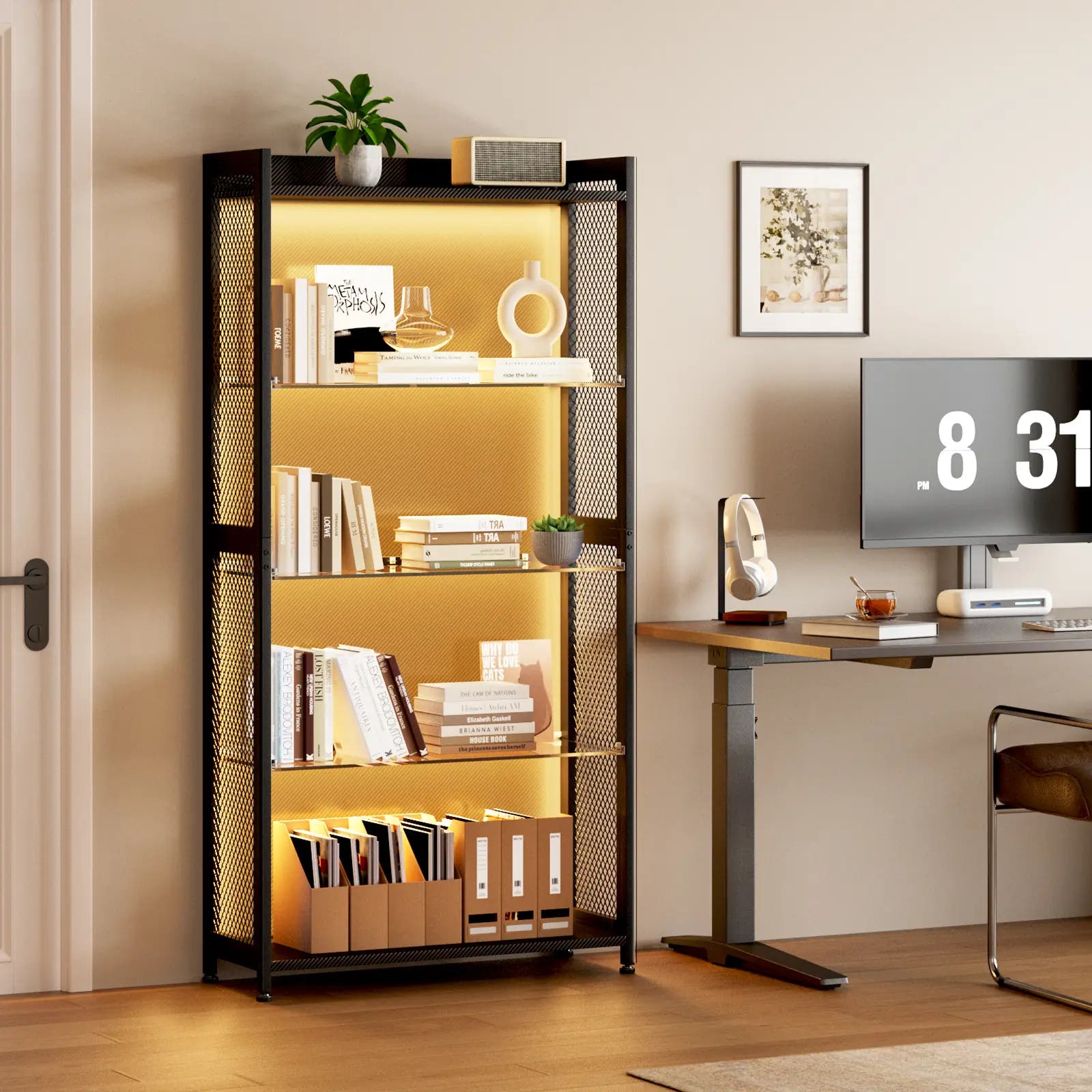 A tall black metal shelving unit with mesh side panels and warm yellow LED lighting, styled with books, binders, a plant, and decor in a home office setting next to a desk with a computer monitor.