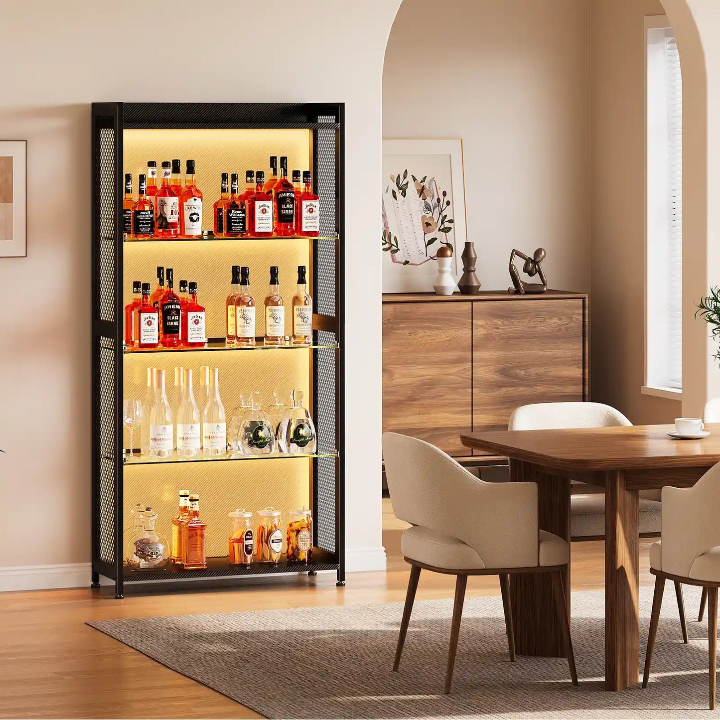 A tall black glass liquor cabinet with warm yellow interior lighting, filled with assorted bottles, shown in a styled dining room setting.