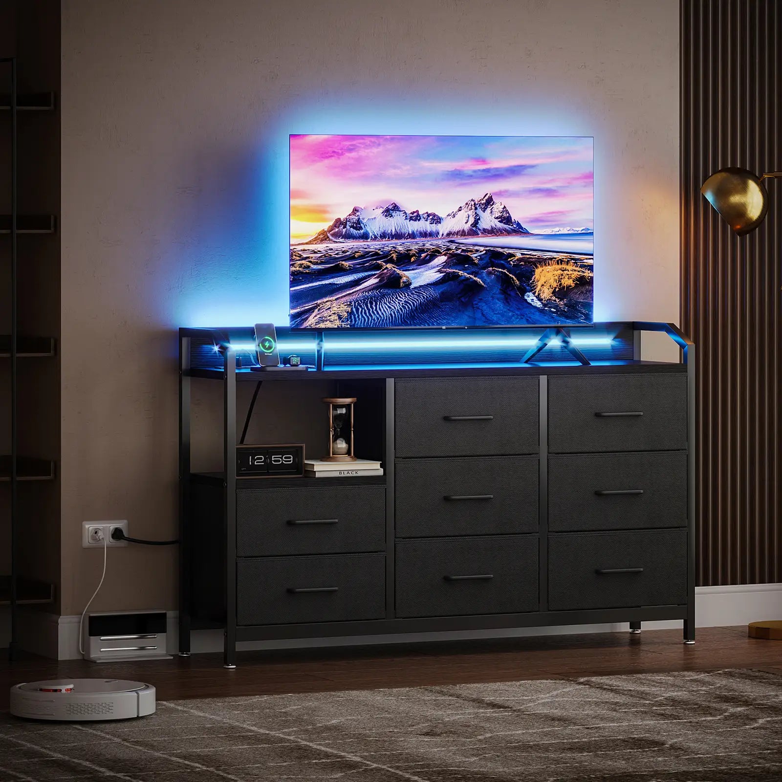 A modern dark gray media console with six drawers, featuring a top shelf holding a TV with a colorful mountain landscape display and blue LED lighting, set in a contemporary living room.