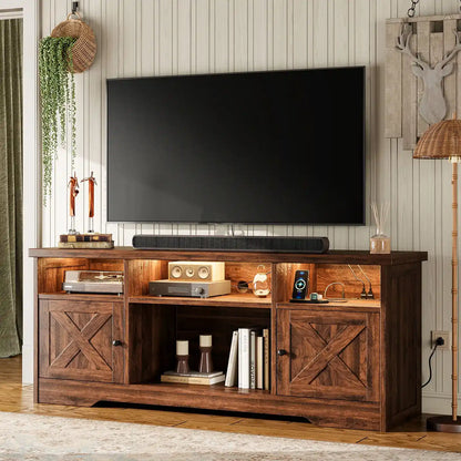 A rustic dark brown wooden TV stand with two cabinet doors and open shelving, styled in a living room setting under a wall-mounted television.